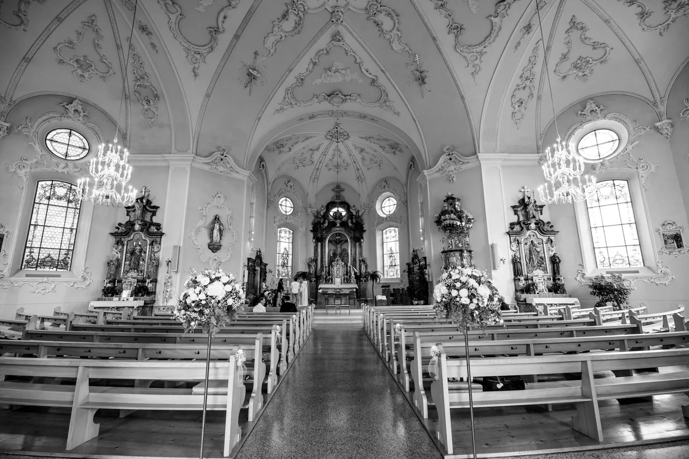 Innenraum der Schlosskirche St. Anton in Schwarzweiss, leere Bänke vor dem Altar